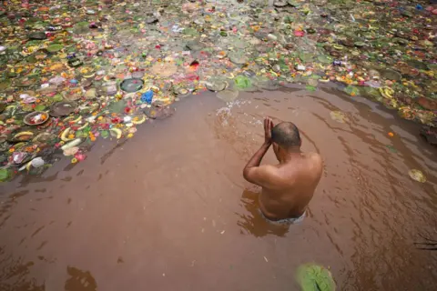 Subaas Shrestha/NurPhoto/REX/Shutterstock A Nepali Hindu is taking a bath in a sacred pond, Matatirtha, on the outskirts of Kathmandu, Nepal