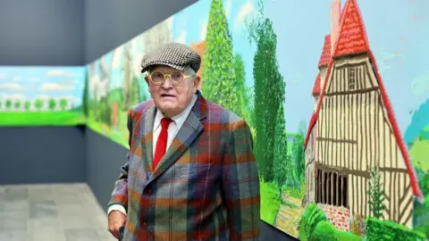Getty Images David Hockney stands alongside his 91m long landscape of Normandy, completed during the coronavirus lockdown