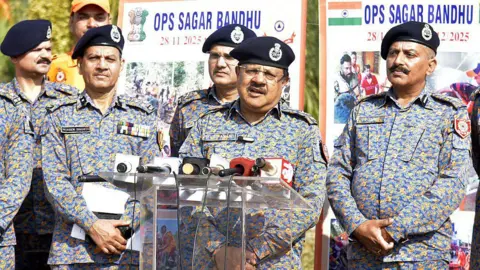 AFP via Getty Images NDRF Director General Piyush Anand briefs the media at the event to felicitate 8th NDRF team from Ghaziabad, which returned after successful mission to Sri Lanka after Cyclone Ditwah under Operation Sagar Bandhu on December 9, 2025 in Ghaziabad, India