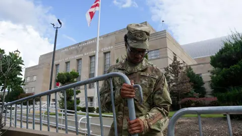 Getty Images A soldier erecting a barricade outside a government building