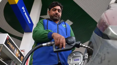 EPA/Shutterstock A petrol station worker fills the tank of a customer's vehicle in Peshawar, Pakistan, 3 April 2026. 