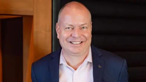 InterContinental Buckhead Atlanta Manuel Deisen, smiling, wearing a white shirt and dark blue suit jacket