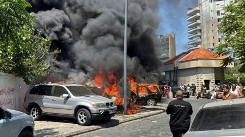 Reuters Smoke rises from burning vehicles following an Israeli strike in the centre of the city of Sidon, southern Lebanon (10 June 2026)