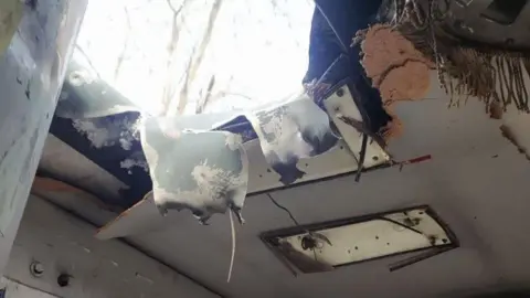 Kherson local administration A gaping hole in the top of a bus