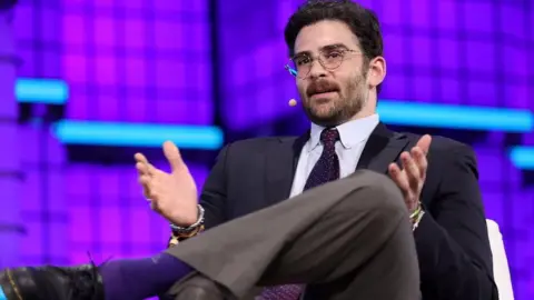 Getty Images Left-wing streamer Hasan Piker speaking while seated