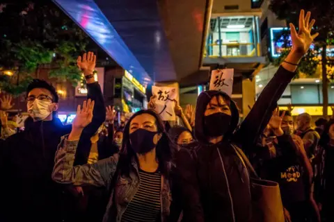 Getty images People chant slogans near a police-cordoned-area to show support for a small group of protesters 