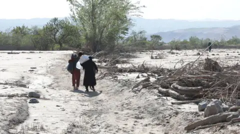Getty Images Civilians are seen after floods caused by heavy downpour as more than 300 were killed and tens of others have gone missing in Baghlan, Afghanistan on May 16, 2024