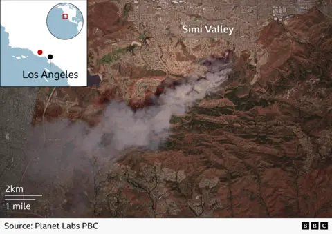A satellite image showing smoke rising from a fire south of Simi Valley