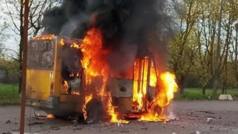 Kherson local authority A yellow bus on fire