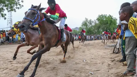 Daniel Beloumou Olomo/AFP Jockeys taking part in the Cameroon International Grand Prix in Maroua, Cameroon - Saturday 11 May 2024