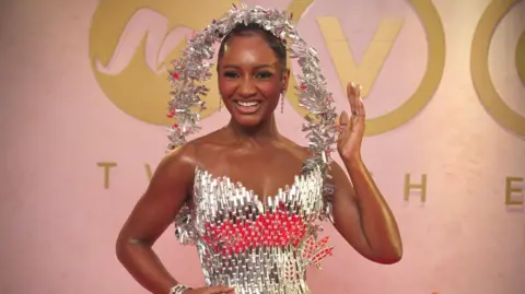 BBC/GIFT UFUOMA Actor and event host Simi Drey is draped in starlight, in a dress entirely made from glass designed by Ovems