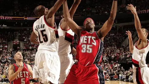 Getty Images Jason Collins #35 of the New Jersey Nets goes strong to the hoop against Travis Outlaw #25 of the Portland Trail Blazers during the game on November 21, 2007 at the Rose Garden in Portland, Oregon.The Blazers won 93-90. 