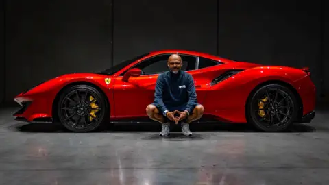 Shaun Baker Ferrari owner Shaun Baker posing for a picture with a bright red 488 Pista.