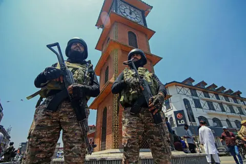 AFP via Getty Images Indian soldiers stand alert near the clock tower in Srinagar, India-administered Jammu and Kashmir, during a Tiranga rally on May 22, 2025 to celebrate the "Operation Sindoor" in which Indian forces conducted missile strikes in Pakistan in the wake of the Pahalgam attack in which 26 civilians were killed on 22 April 2025. (Photo by Faisal Khan / Middle East Images / Middle East Images via AFP) (Photo by FAISAL KHAN/Middle East Images/AFP via Getty Images)