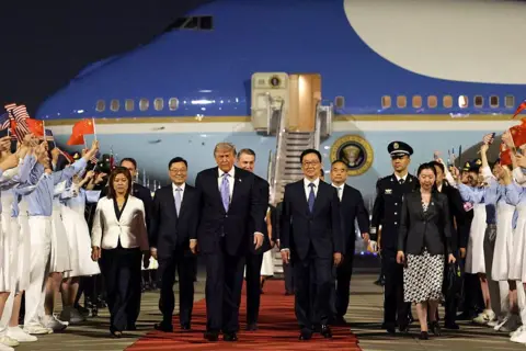 Getty Images Donald Trump is joined by Vice-President of China Han Zheng and other Chinese officials as he arrives in Beijing on 13 May