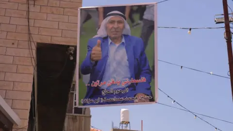 A picture of Hussein Asasa hanging in the air.
