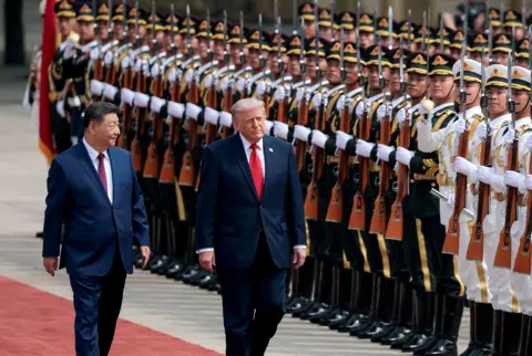 Reuters U.S. President Donald Trump inspects an honour guard during a welcome ceremony with Chinese President Xi Jinping at the Great Hall of the People in Beijing, China, May 14, 2026