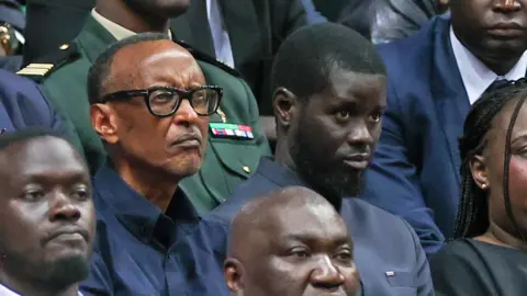 Cem Ozdel/Getty Images The presidents of Rwanda, Paul Kagame (L), and Senegal, Bassirou Diomaye Faye (R), watch a basket ball match in Dakar, Senegal - Sunday 12 May 2024