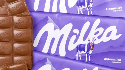 Alamy Milka Alpenmilch chocolate bar in purple packaging