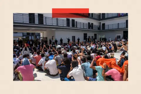 Reuters Hundreds of people sit cross legged in rows on a floor in an outdoors atrium