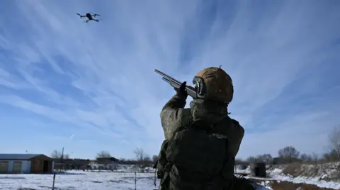 Reuters A Russian soldier, in uniform, aims at a drone while undergoing an intensive combat training course
