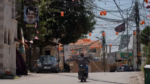 Neha Sharma/BBC A man rides a motorcycle in Arab Salim, a village in southern Lebanon