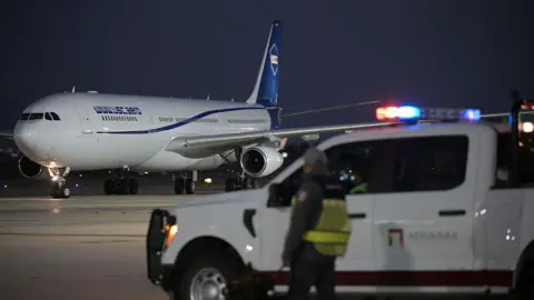 Getty Images A customs officer looks at the plane carrying Iran's football team while landing at the Tijuana International Airport in Tijuana, Mexico on June 7, 2026, ahead of the FIFA 2026 World Cup football tournament. (Photo by Guillermo Arias / AFP via Getty Images)