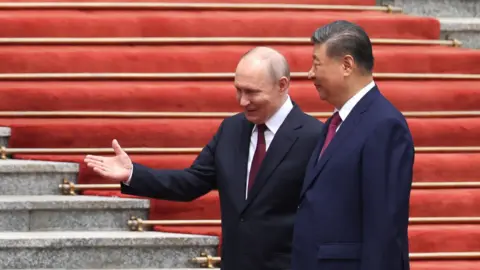 EPA Russian President Vladimir Putin (L) walks with Chinese President Xi Jinping (R) during a welcoming ceremony at the Great Hall of the People in Beijing, China, 20 May 2026.