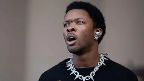 Getty Images D4vd with mouth open, wearing chain necklace