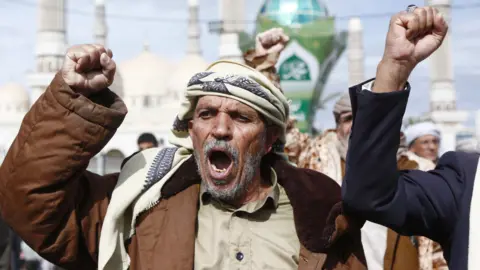 Getty Images Houthi loyalists chant slogans as they participate in a protest staged to show support to Iran in Sanaa