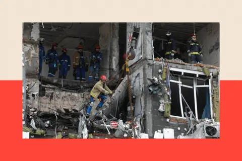 EPA/Shutterstock Ukrainian rescuers work at the site of a Russian strike on a high-story residential building in Kyiv, Ukraine