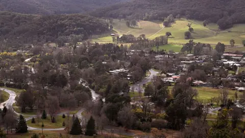 Getty Images A birds-eye view shows the township of Porepunkah, a cluster of buildings and roads surrounded by green hills and dense bushland