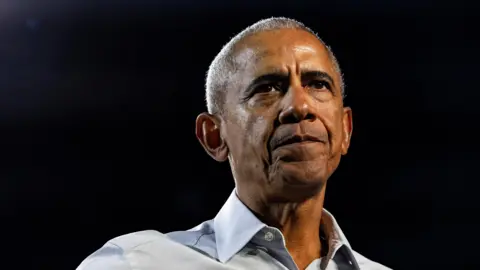 Reuters Close up of Barack Obama with a serious expression. He is wearing a pale shirt.