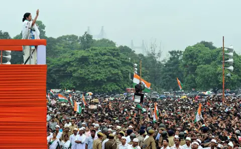 AFP via Getty Images India's West Bengal state Chief Minister Mamata Banerjee addresses supporters during a mass rally organised by the Trinamool Congress Party (TMC) at the Brigade Parade ground in Kolkata on July 21, 2011. 