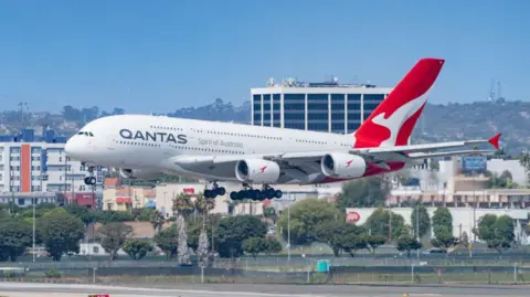 Getty Images A Qantas Airways Airbus A380 descends at Los Angeles International Airport, with the city in the background