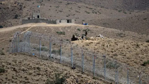 Getty Images File photo of a Pakistani soldier standing beside a barb-wire fencing in North Waziristan, along Pakistan's border with Afghanistan