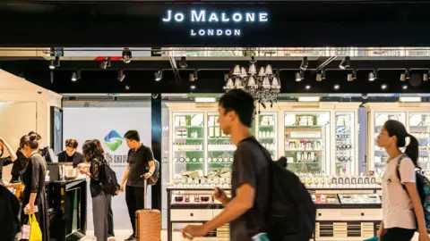 Getty Images A Jo Malone shop with people walking past it.