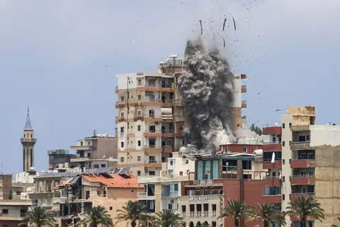 AFP Smoke and debris rise following an Israeli air strike in Tyre, southern Lebanon (9 June 2026)