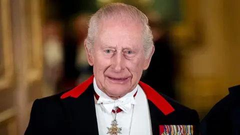 Getty Images King Charles III standing for a formal photograph before a state banquet