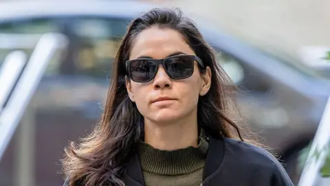 Bloomberg via Getty Images Shivon Zilis wearing sunglasses, a dark blue jacket and a dark green jumper