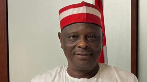 Rabiu Kwankwaso/X Rabiu Kwankwaso looks ahead, wearing his trademark red cap and a white top.