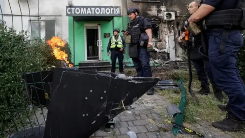 Reuters Police experts work at the site a Russian drone strike in Ukraine's north-eastern city of Kharkiv. Photo: 10 June 2026
