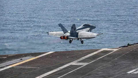 US Navy via Getty Images A US fighter jet takes off. 