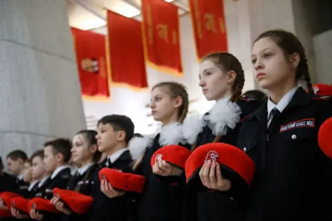 AFP via Getty Images Russian teenagers with red berets take part in a ceremony of joining a patriotic cadet movement of the Youth Army