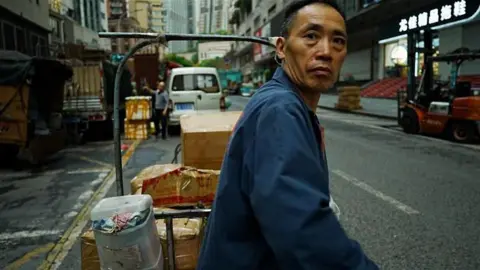 A worker pulling a cart in Chongqing.
