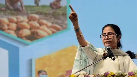 NurPhoto via Getty Images West Bengal Chief Minister Mamata Banerjee addresses a public meeting in Singur, Hooghly district, on January 28, 2026. (Photo by Debajyoti Chakraborty/NurPhoto via Getty Images)