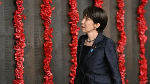 Getty Images Prime Minister Sanae Takaichi walks past poppies on the Roll of Honour during her visit to the Australian War Memorial in Canberra on May 4, 2026.