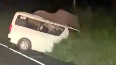 Uganda Police Force A police handout shows a the white vehicle after it crashed in Murchison Falls National Park in Uganda.