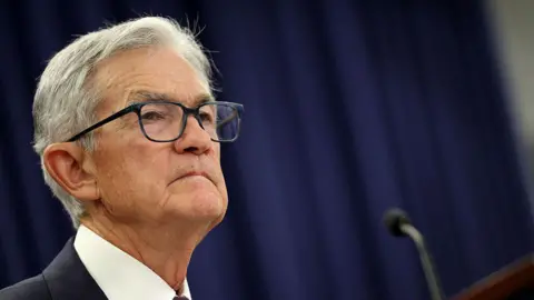 Getty Images Jerome Powell : headshot of man in shirt and jacket in front of microphone