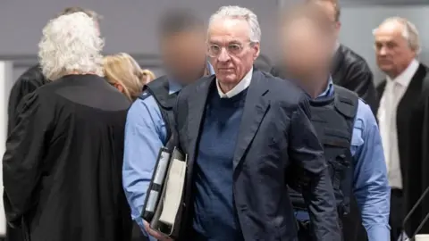 Boris Roessler/Pool via REUTERS At the start of the trial against the alleged "Reich Citizens" group, the main defendant Heinrich XIII. Prince Reuss was brought to the hearing room in the Sossenheim branch of the Frankfurt Higher Regional Court